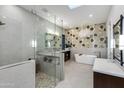 Elegant bathroom features a glass-enclosed shower, soaking tub and stylish vanity with dual sinks at 6512 N 31St Way, Phoenix, AZ 85016