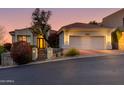 Well-lit home exterior showcases desert landscaping, steps to front entry and three-car garage at 6512 N 31St Way, Phoenix, AZ 85016