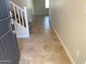 Inviting foyer featuring neutral tile floors, staircase with white railing, and an open floor plan at 7216 E Blissful Breeze Ln, San Tan Valley, AZ 85143