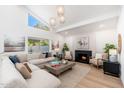 Spacious living room with a cozy fireplace, large windows, and stylish furnishings at 7223 N 14Th St, Phoenix, AZ 85020
