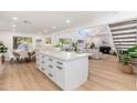 Open living space with kitchen island, dining area, and living room featuring a fireplace and skylights at 7223 N 14Th St, Phoenix, AZ 85020