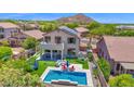 Stunning backyard featuring a sparkling pool, lush turf, and mountain views at 7260 E Tasman St, Mesa, AZ 85207