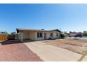 Charming single-story home with desert landscaping and covered carport at 8339 W Devonshire Ave, Phoenix, AZ 85037