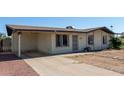 Charming single-story home with desert landscaping and covered carport at 8339 W Devonshire Ave, Phoenix, AZ 85037