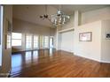 Bright living area boasts hardwood floors, high ceilings, and access to a patio through glass doors at 9285 E Sutton Dr, Scottsdale, AZ 85260