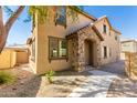Charming home with a stone-covered porch, surrounded by desert landscaping and a welcoming walkway at 935 E Agua Fria Ln, Avondale, AZ 85323