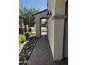This side yard offers a covered walkway, pavers, and desert rock landscaping at 10704 E Twister Ave, Mesa, AZ 85212