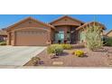 Charming single-story home featuring a desert landscaped yard and covered front patio seating area at 11242 E Onza Ave, Mesa, AZ 85212