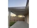 A covered patio with string lights and a backyard view provides an entertainment space at 12501 W Rosewood Dr, El Mirage, AZ 85335