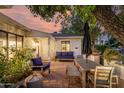 Outdoor patio area featuring a dining set, lounge seating, and a brick-paved floor perfect for entertaining at 1625 N 11Th Ave, Phoenix, AZ 85007