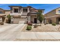 Charming two-story home with neutral stucco, stylish grey accents and a well-manicured, low maintenance front yard at 16386 W Sierra St, Surprise, AZ 85388