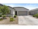 Lovely home featuring a two-car garage, neutral color palette, and low-maintenance landscaping at 16617 W Desert Mirage Dr, Surprise, AZ 85388