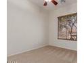 Cozy bedroom with neutral carpet, ceiling fan, and a large window offering scenic views at 16813 S 30Th Ave, Phoenix, AZ 85045