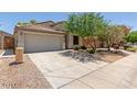Single-Gathering home featuring desert landscaping and a two-car garage with an extended driveway at 16813 S 30Th Ave, Phoenix, AZ 85045