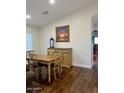 Cozy dining room featuring a wooden table with chairs, complemented by a decorative painting at 1898 N Hubbard Ln, Casa Grande, AZ 85122