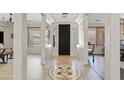 Elegant foyer with decorative tile flooring, a black front door, and bright, open space at 19339 E Mockingbird Dr, Queen Creek, AZ 85142