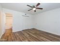 Comfortable bedroom with hardwood floors, closet, and ceiling fan at 222 W Brown Rd # 72, Mesa, AZ 85201