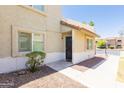 Lovely townhome exterior with a covered porch, desert landscaping, and a secure metal front door at 222 W Brown Rd # 72, Mesa, AZ 85201