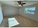 Open living room featuring tile floors and a bright window at 2331 W Via Rialto Cir, Mesa, AZ 85202