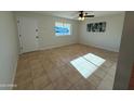 Spacious living room with natural light and a ceiling fan at 2331 W Via Rialto Cir, Mesa, AZ 85202