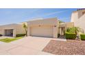 This home's exterior features a large driveway leading to the attached two-car garage and gated courtyard at 2413 E Rancho Dr, Phoenix, AZ 85016
