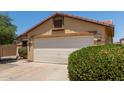 Charming single-story home with two car garage, mature landscaping and desert front yard at 25060 W Vista Norte St, Buckeye, AZ 85326