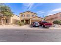 Two-story home with a front-facing two car garage and low maintenance desert landscaping at 2509 E Meadow Land Dr, San Tan Valley, AZ 85140