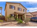 Two-story home with a front-facing two car garage and low maintenance desert landscaping at 2509 E Meadow Land Dr, San Tan Valley, AZ 85140