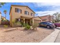 Two-story home with a front-facing two car garage and low maintenance desert landscaping at 2509 E Meadow Land Dr, San Tan Valley, AZ 85140