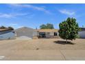 Charming single-story home featuring a two-car garage, manicured lawn, and attractive desert landscaping at 3116 W Calavar Rd, Phoenix, AZ 85053