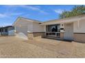 Welcoming single-story home featuring a two-car garage, desert landscaping, and a brick pathway at 3116 W Calavar Rd, Phoenix, AZ 85053