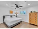 Bright and airy bedroom with hardwood floors, a large bed, and ample natural light at 3505 N Miller Rd, Scottsdale, AZ 85251