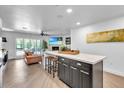 Bright, open-concept kitchen with a large center island and seamless connection to the living room at 3505 N Miller Rd, Scottsdale, AZ 85251