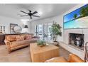 Cozy living room with modern decor, brick fireplace, and entertainment center at 3505 N Miller Rd, Scottsdale, AZ 85251
