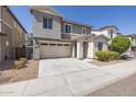 Two-story house with a two-car garage, gray stucco, and stone accents at 3710 E Cheery Lynn Rd, Phoenix, AZ 85018