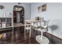 Dining area with dark wood floors, decorative painting, and modern, minimalist furnishing at 3825 E Camelback Rd # 152, Phoenix, AZ 85018