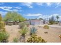 Property exterior with xeriscape landscaping, including agave, yucca, and other desert plants at 4032 E Cannon Dr, Phoenix, AZ 85028
