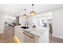 Elegant kitchen featuring a marble island with pendant lighting, an undermounted sink, and stainless appliances at 4079 E Yucca St, Phoenix, AZ 85028