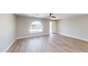 Well-lit living room with wood-look floors, white trim, and a bright window at 4151 E Clovis Ave, Mesa, AZ 85206