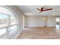 Bright and spacious living room featuring new flooring and a decorative ceiling fan at 4151 E Clovis Ave, Mesa, AZ 85206