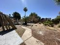 This backyard features a covered patio, desert landscaping, and a block fence, awaiting your personal touch at 4219 E Whitney Ln, Phoenix, AZ 85032