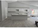 Bright kitchen with white cabinets, an island and modern countertops at 4219 E Whitney Ln, Phoenix, AZ 85032