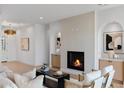Bright living room featuring a fireplace, hardwood floors, and modern decor at 4301 E Sells Dr, Phoenix, AZ 85018