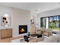 Bright living room featuring a fireplace, hardwood floors, and a seamless indoor-outdoor flow at 4301 E Sells Dr, Phoenix, AZ 85018