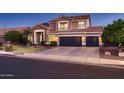 Charming two-story home with a well-manicured lawn and a three-car garage at 4437 E Dartmouth St, Mesa, AZ 85205