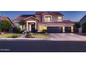 Charming two-story home with a well-manicured lawn and a three-car garage at 4437 E Dartmouth St, Mesa, AZ 85205