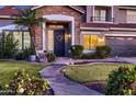 Inviting home entrance with stone accents, manicured lawn, and welcoming wreath at 4437 E Dartmouth St, Mesa, AZ 85205