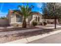 The beautiful exterior features unique architectural details, desert landscaping, and a well-maintained yard at 4667 E Reins Rd, Gilbert, AZ 85297