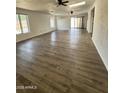 Bright open-concept living area with a neutral color palette, wood-look flooring, and lots of natural light at 4916 W Earll Dr, Phoenix, AZ 85031
