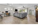 Spacious living room with tile flooring, ceiling fan, and sliding glass doors at 5303 W Hackamore Dr, Phoenix, AZ 85083